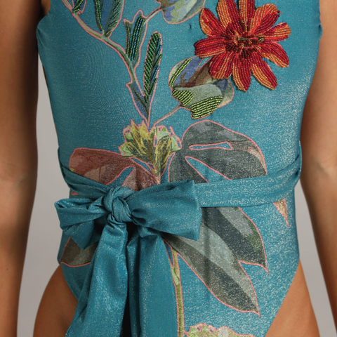 High neck halter one piece featuring waist bow and handcrafted floral texture.
