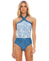 woman wearing a blue One-Piece Swimsuit thatfeatures an adjustable crossover high neck design. 