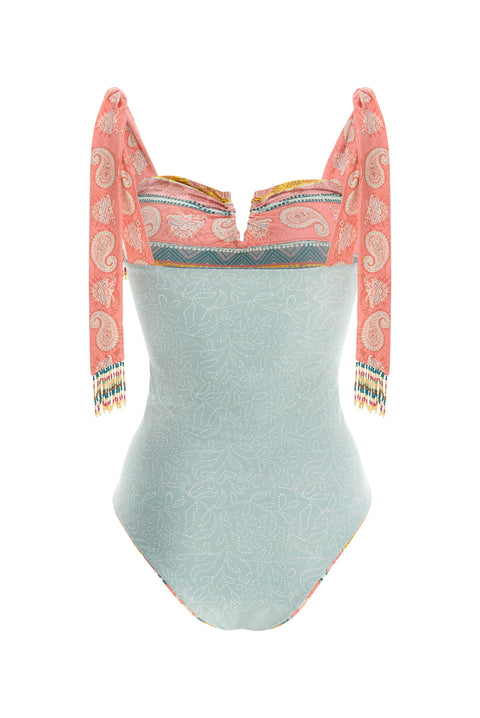 Reversible One-Piece that features over-the-shoulder ties with handmade beading detail at the ends. The V-wire front and inner cups create a flattering bustline. This suit has moderate bottom coverage.