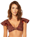 woman wearing red animal print top that features ruffle sleeves, o-ring trim and removable cups. 